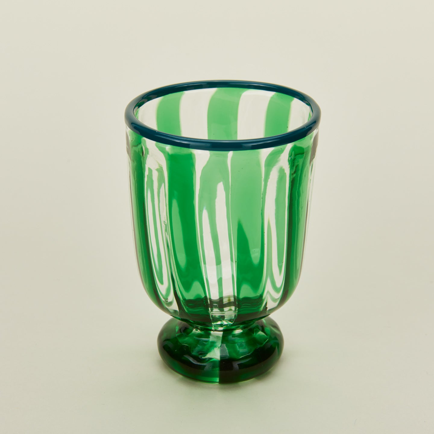 Close up view of green striped wine glass