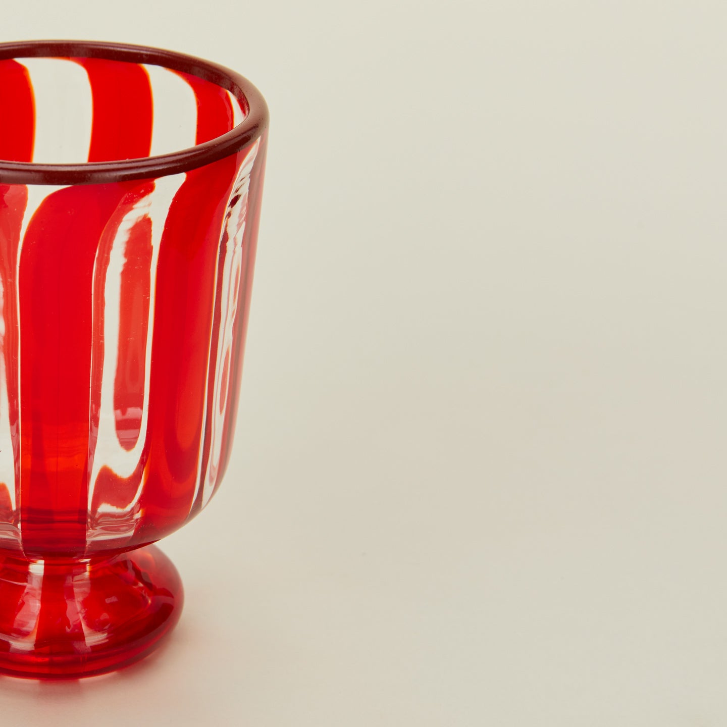 Close up view of striped wine glass in red