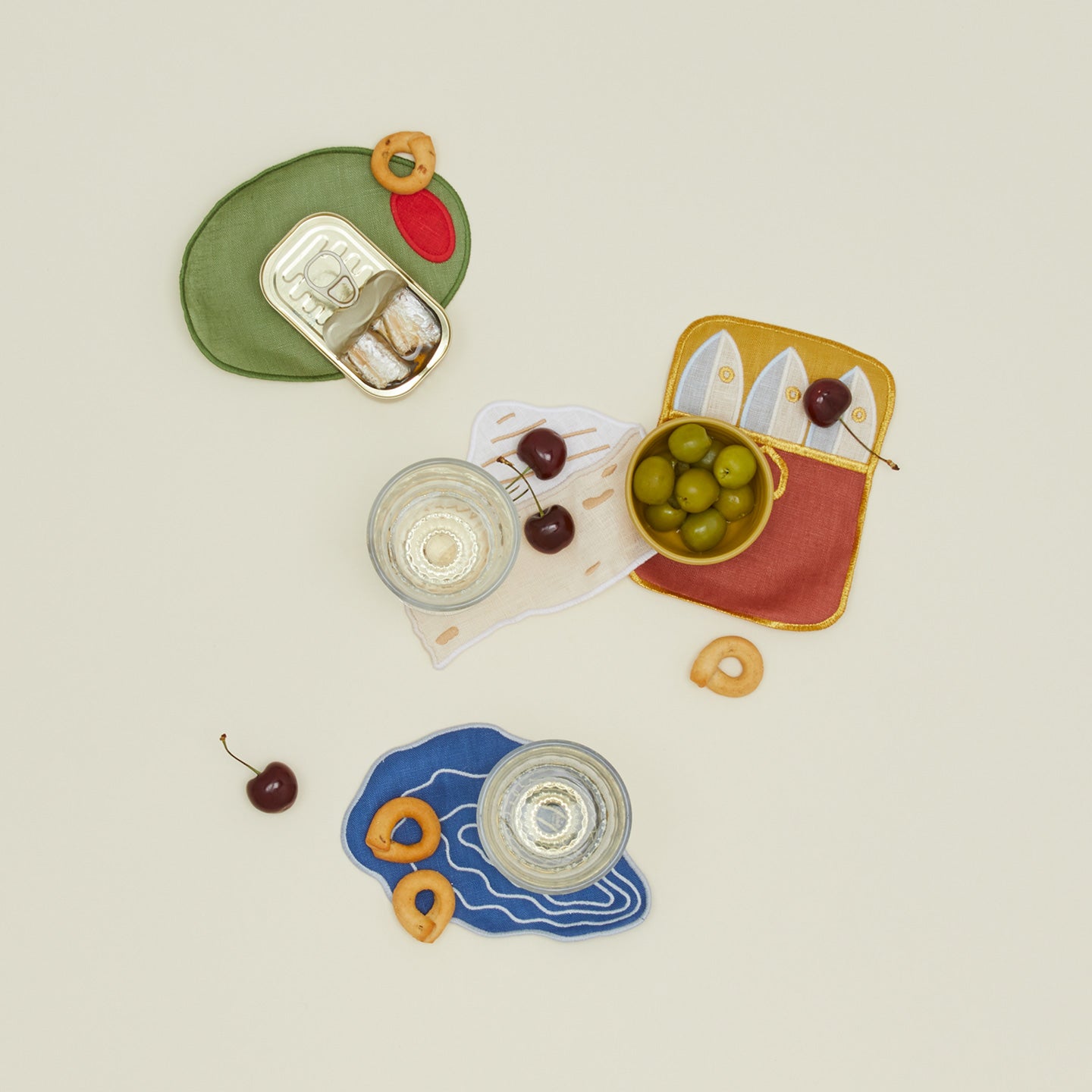 Hors doeuvres cocktail napkins with olives, cherries, and bread