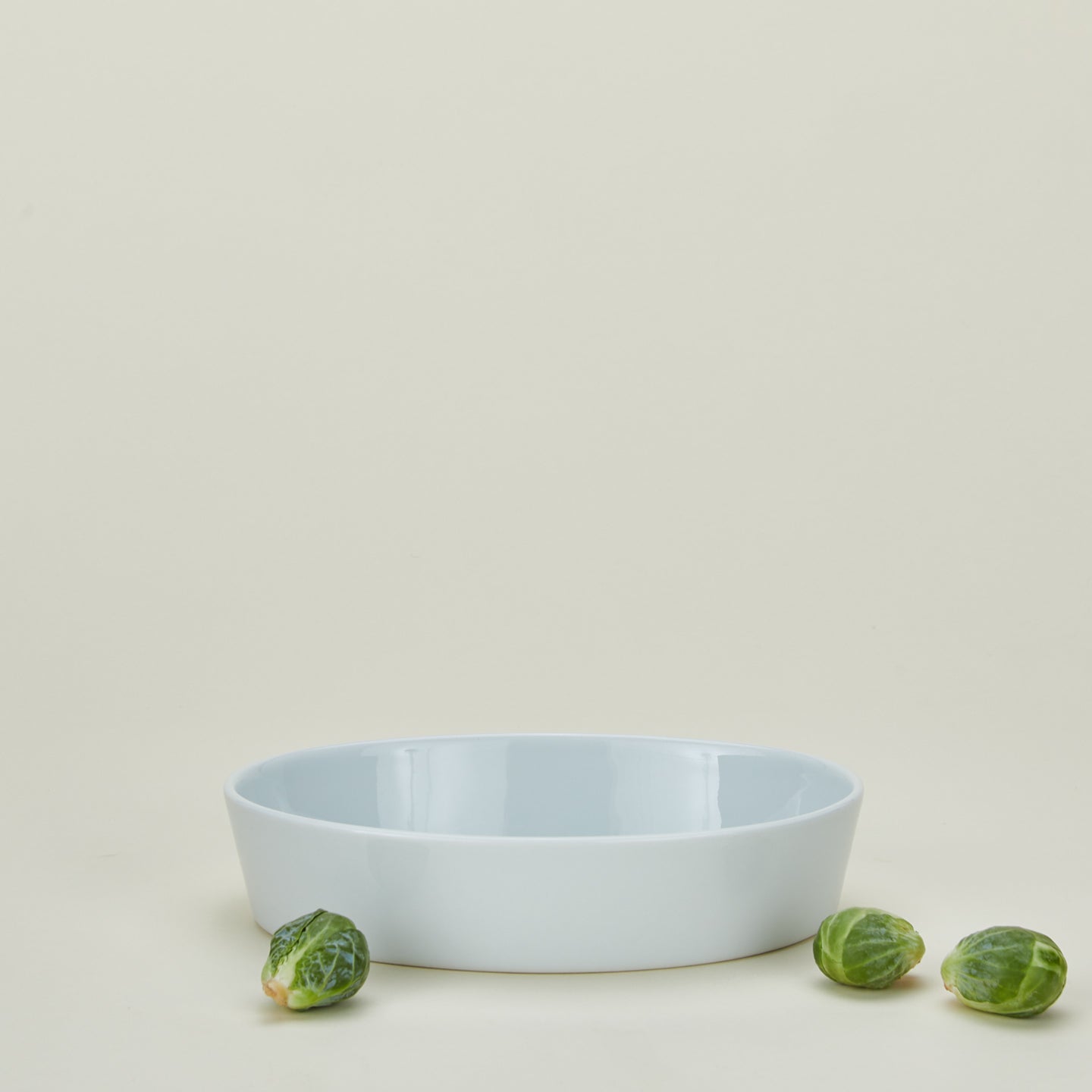 Medium porcelain deep oval baker in white with brussels sprouts
