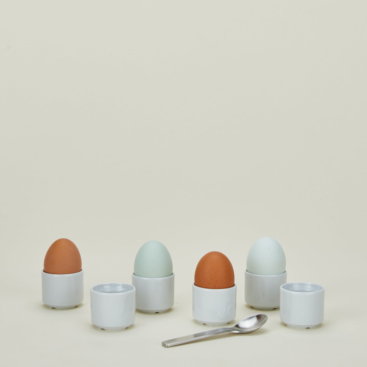 Set of 6 porcelain european style egg cups in white with eggs and spoon