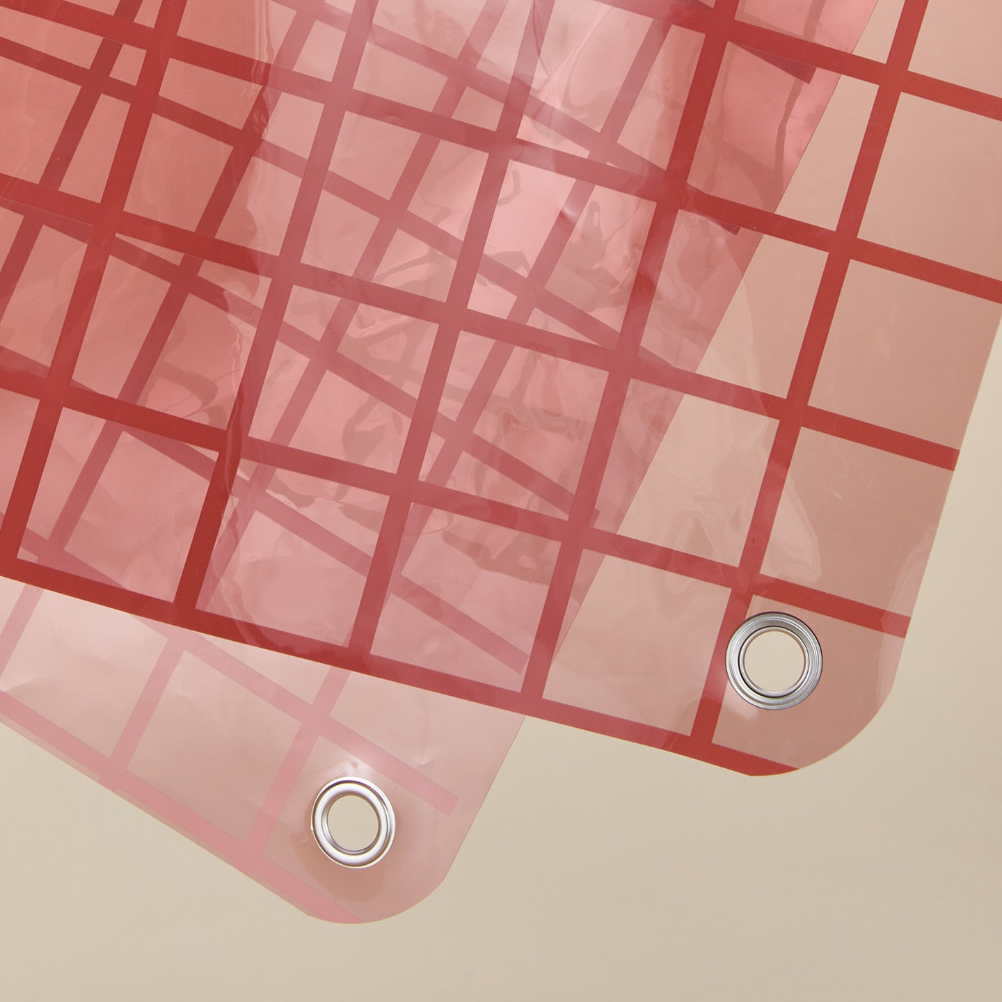 Close up view of sun grid shower curtain in rose.