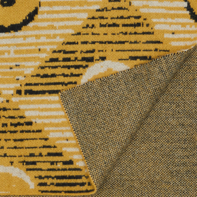white, yellow and black patterned rug