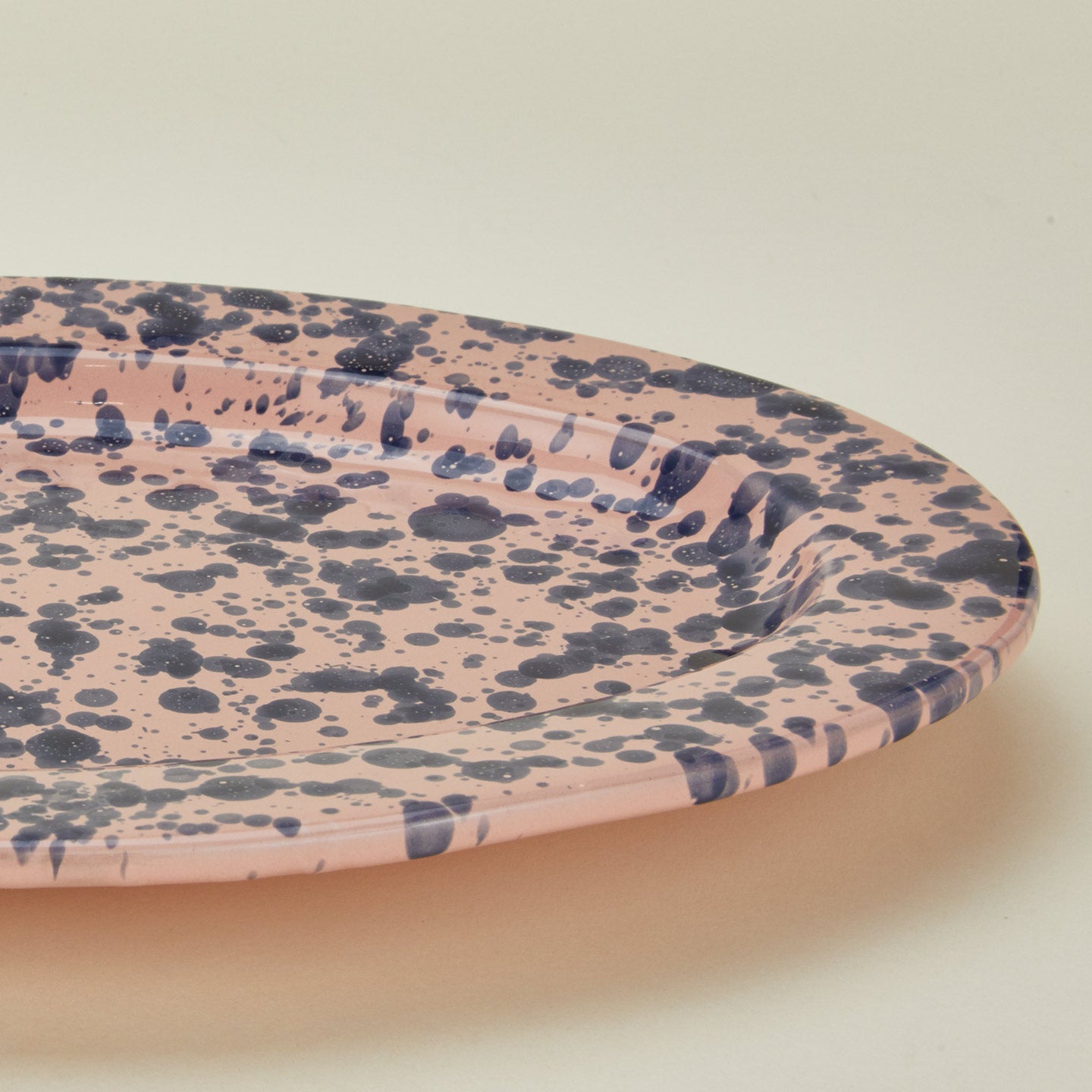 Close up view of Splatter pink and blue oval platter