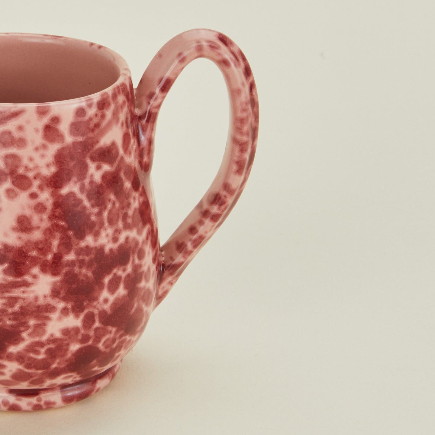 Close up view of Splatter mug in pink and red