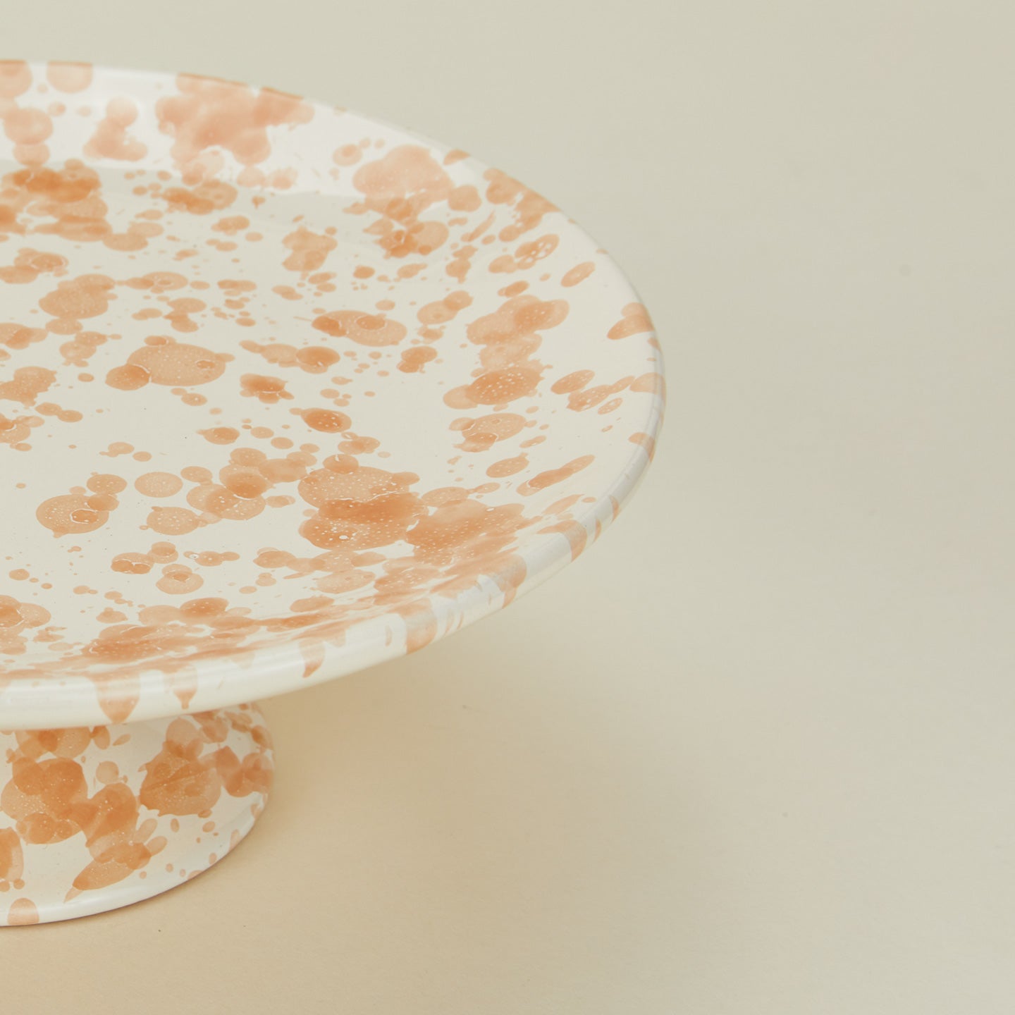 Close up view of Splatter cake stand in tan and ivory