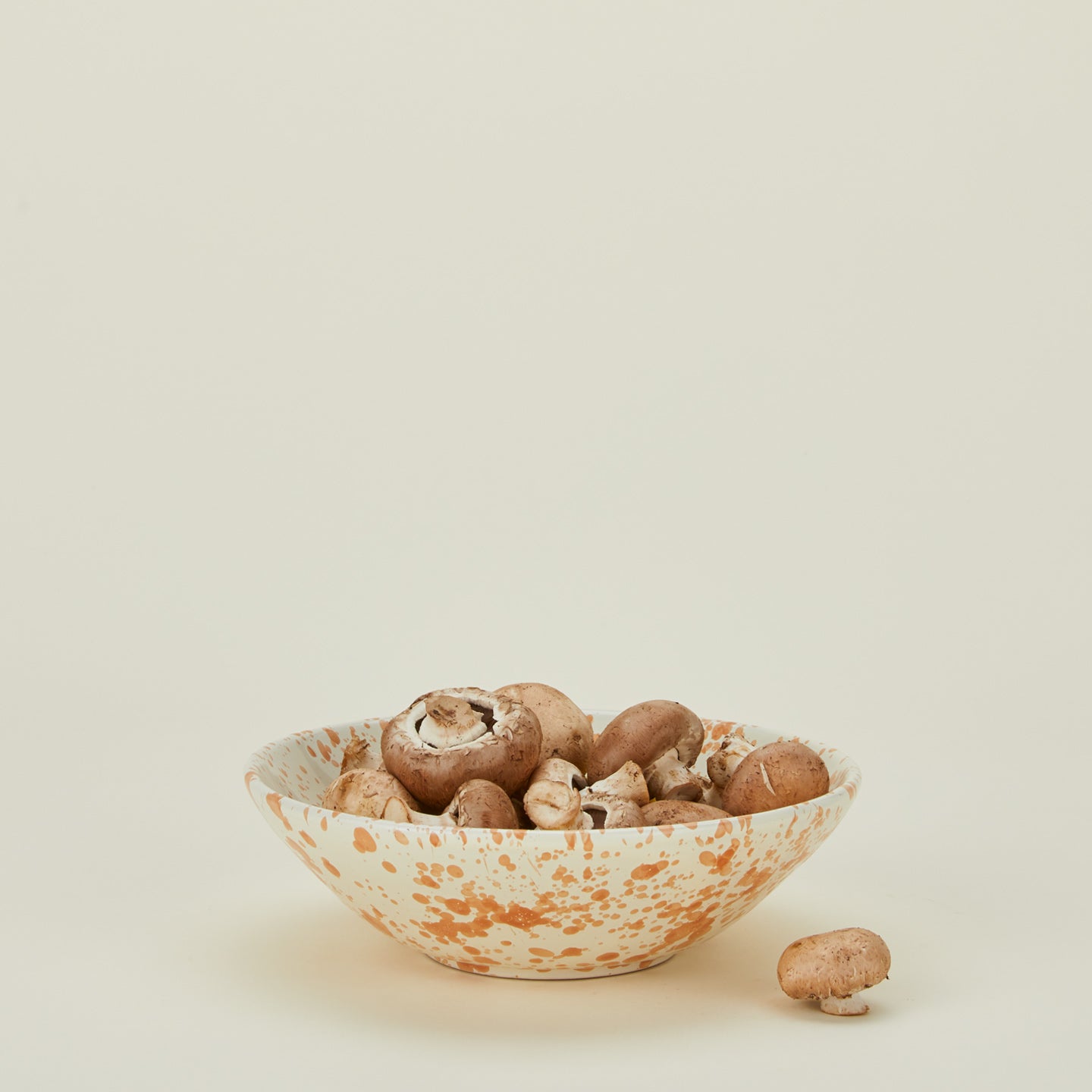 Splatter low bowl in tan and ivory with mushrooms
