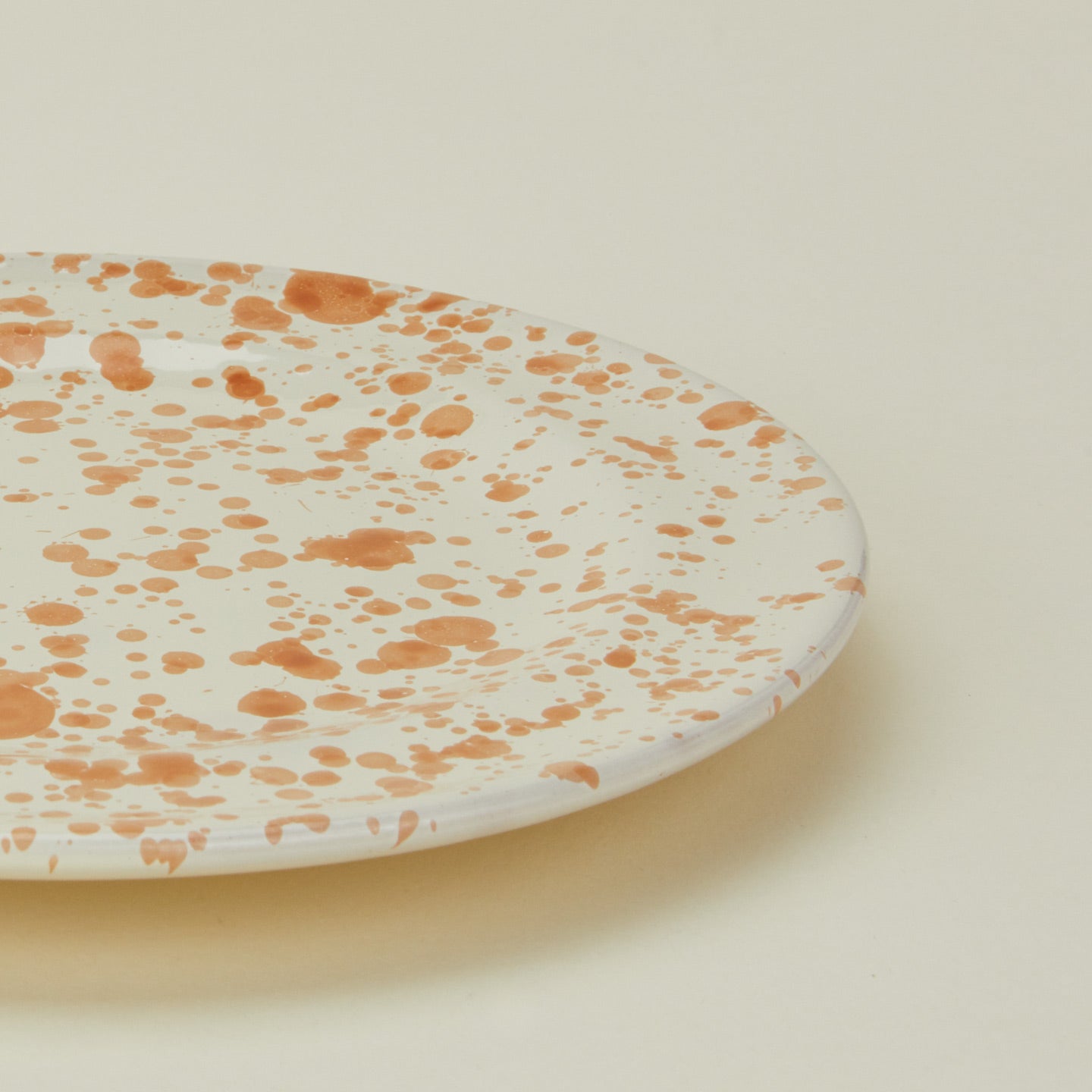 Close up view of Splatter salad plate in tan and ivory