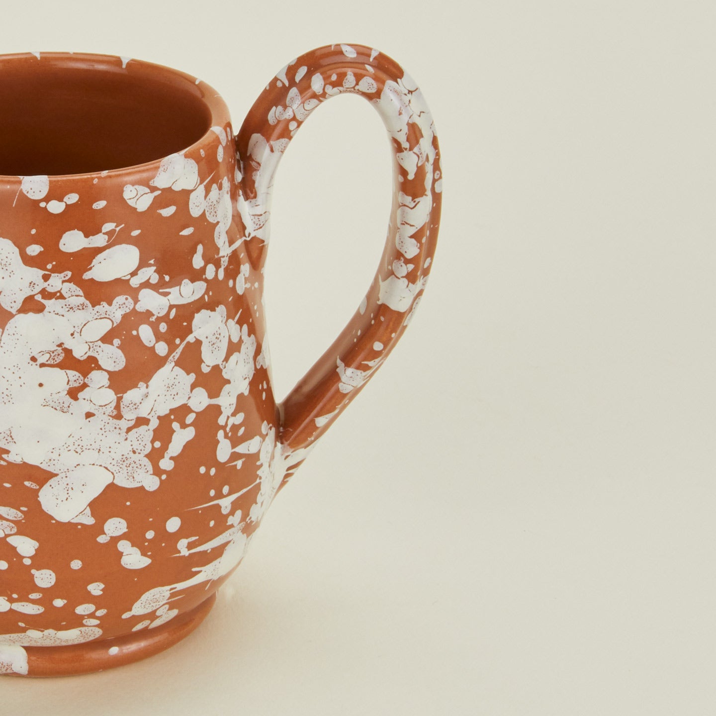 Close up view of Splatter mug in terracotta and ivory