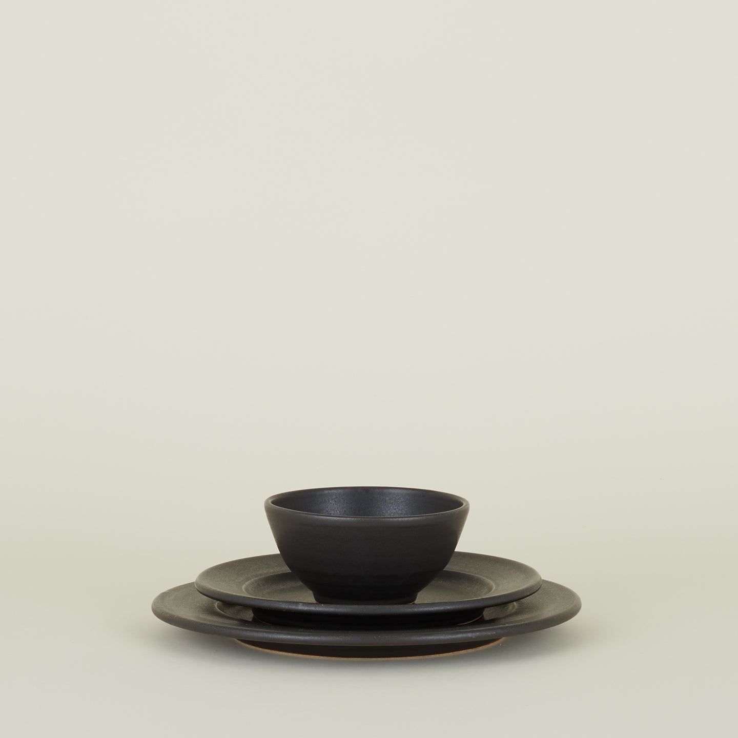 Stoneware Bowl, Salad Plate and Dinner Plate in Black, stacked.