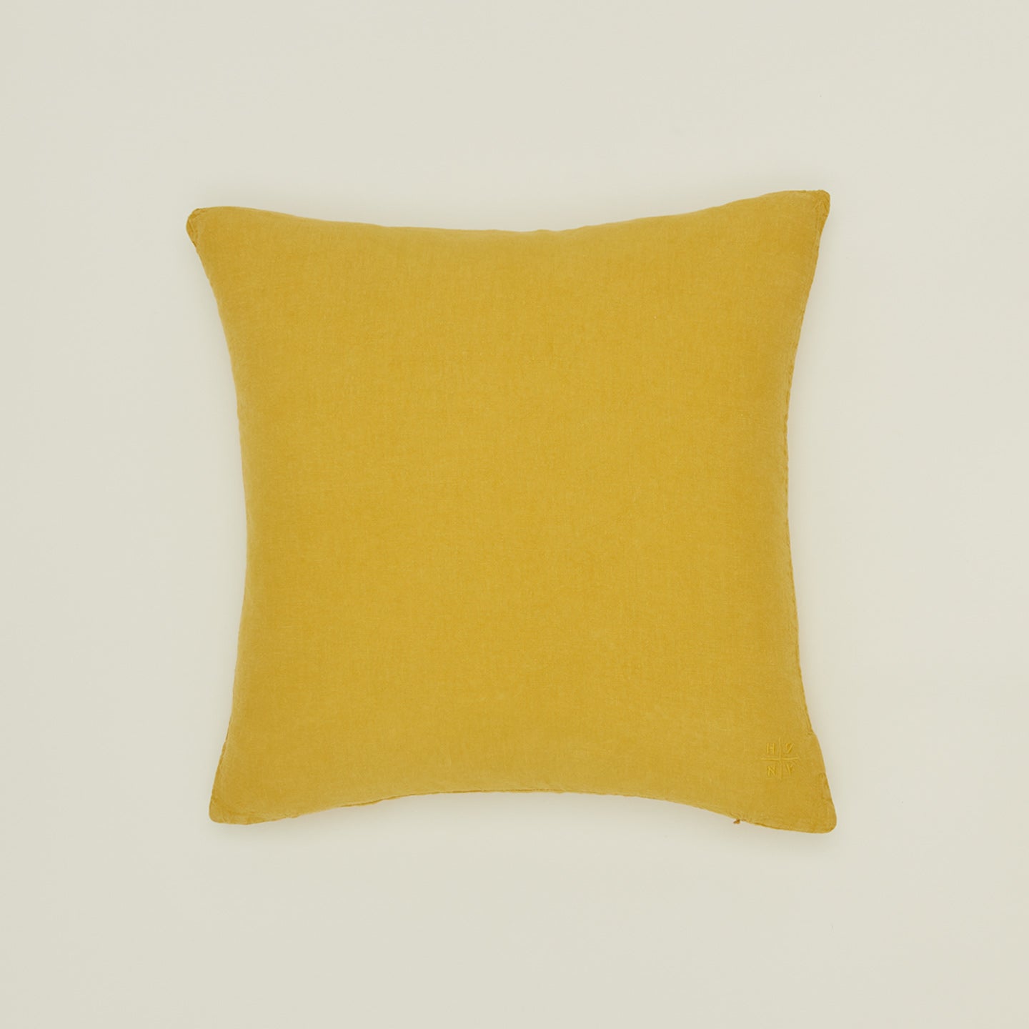 Simple linen pillow in mustard
