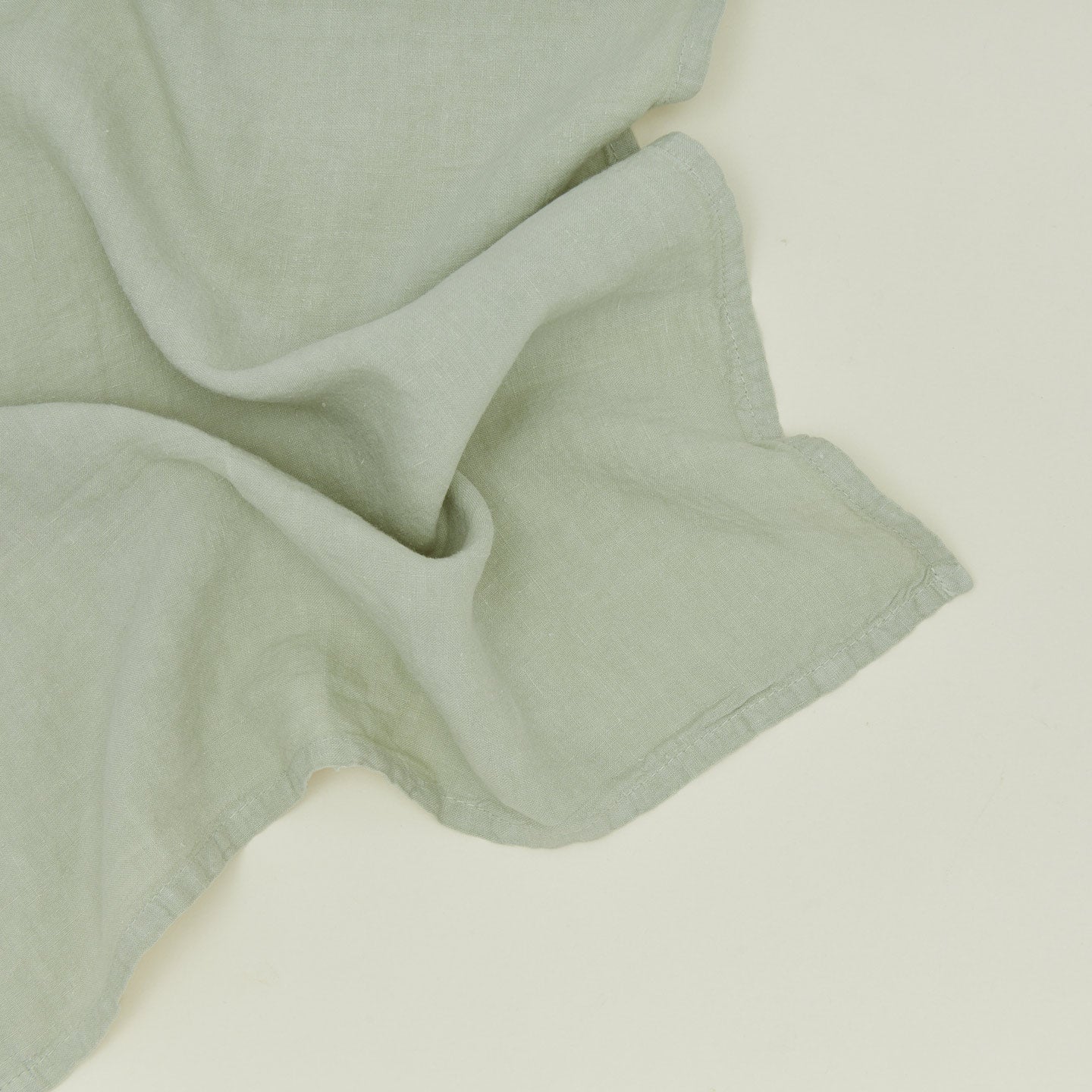 Detailed view of simple linen napkin in sage