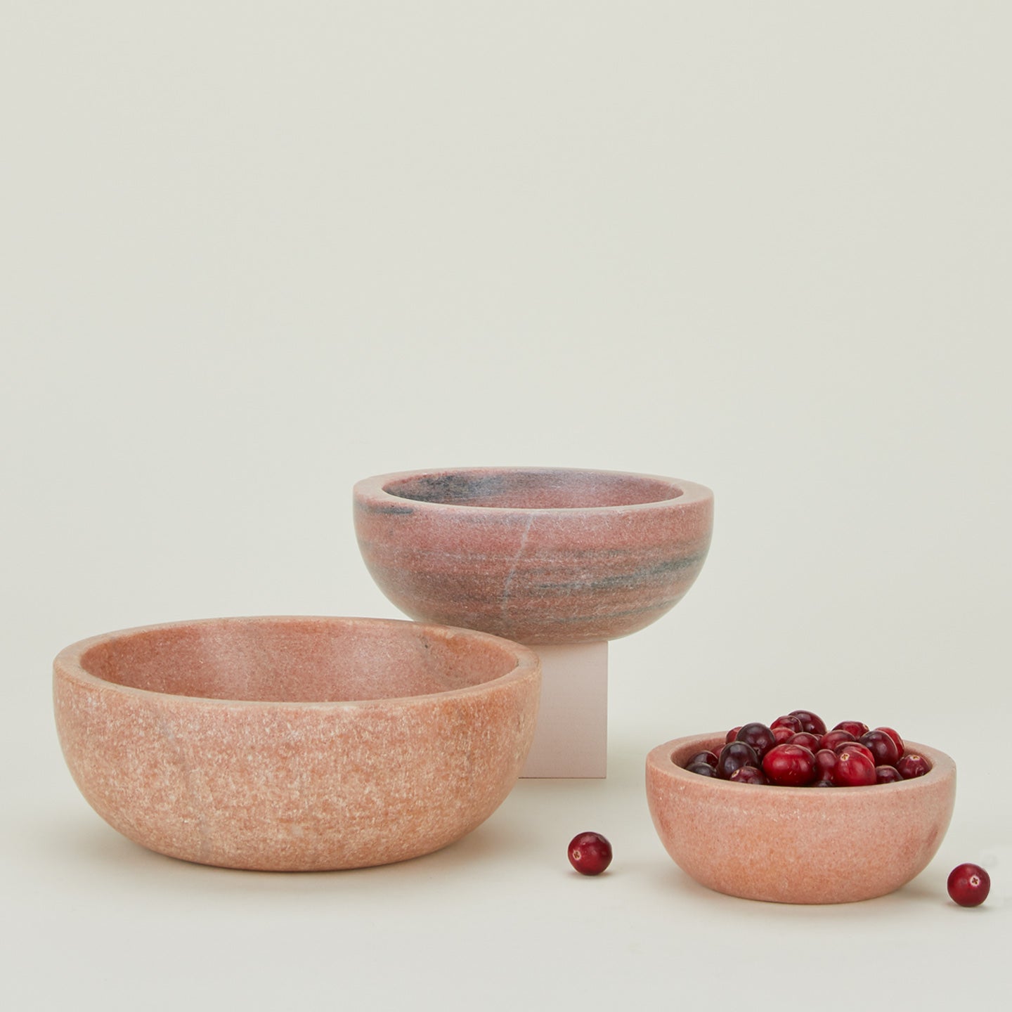 Three Simple Marble Bowls in various sizes in Pink, with cranberries.