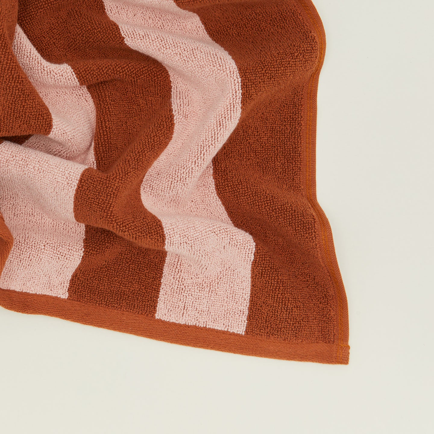 Close up of Simple Striped Terry Bath Mat in blush and terracotta.