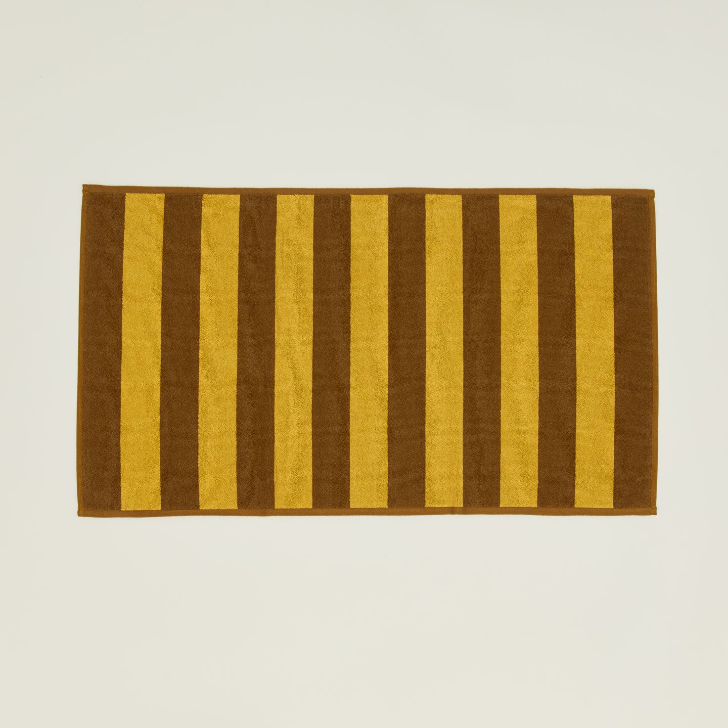 Simple Striped Terry Bath Mat in mustard and bronze.