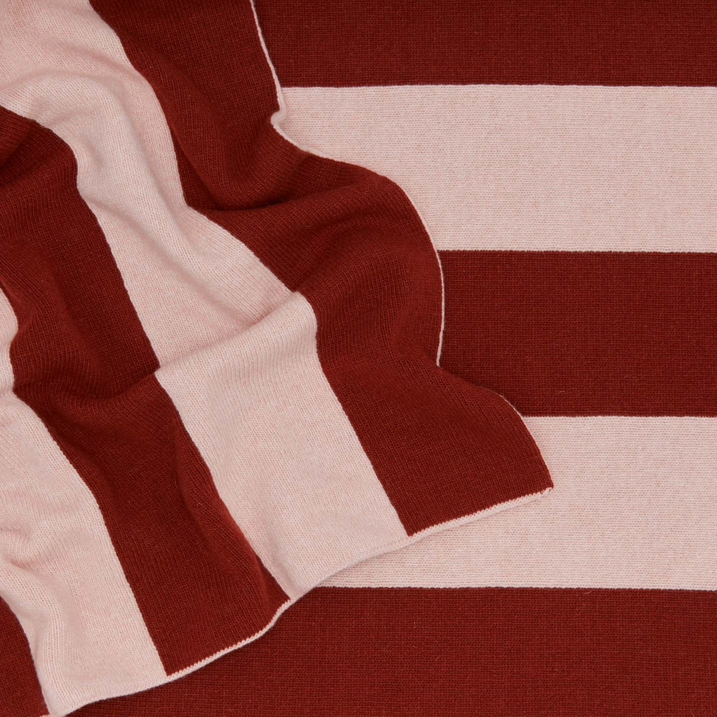 Striped throw in terracotta and blush close up