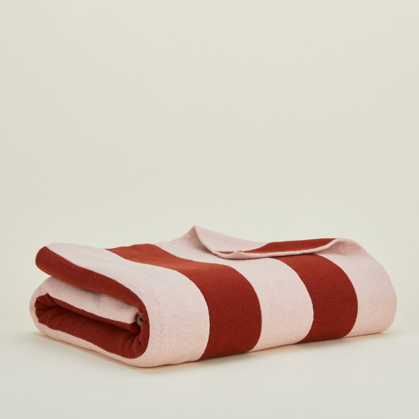 Folded simple striped throw in blush and terracotta