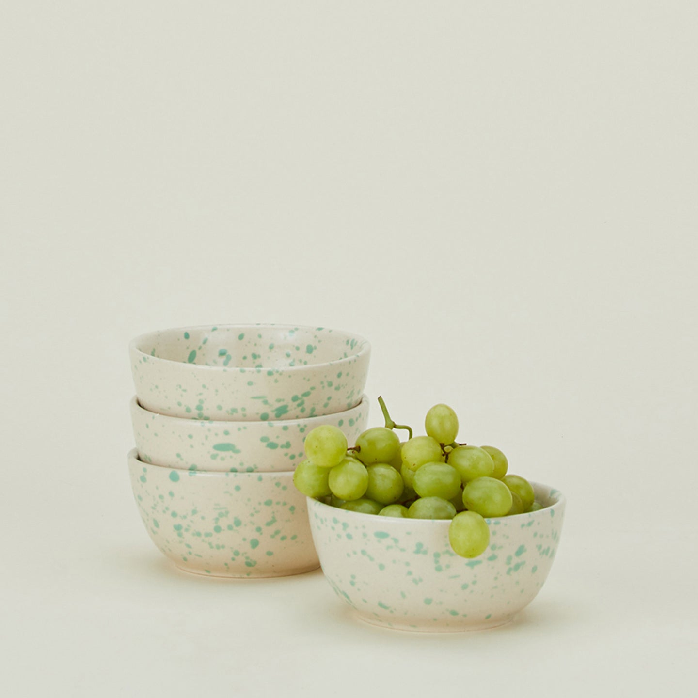 Set of four Splatterware bowls in Pool with grapes.