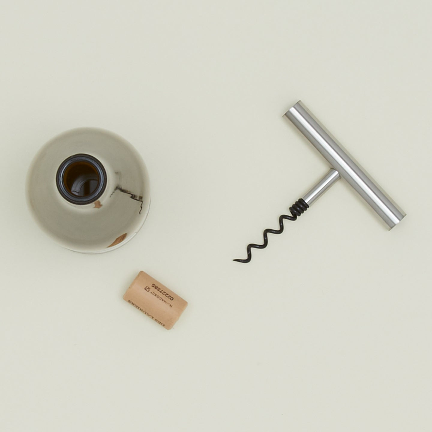Steel Corkscrew with bottle of wine.