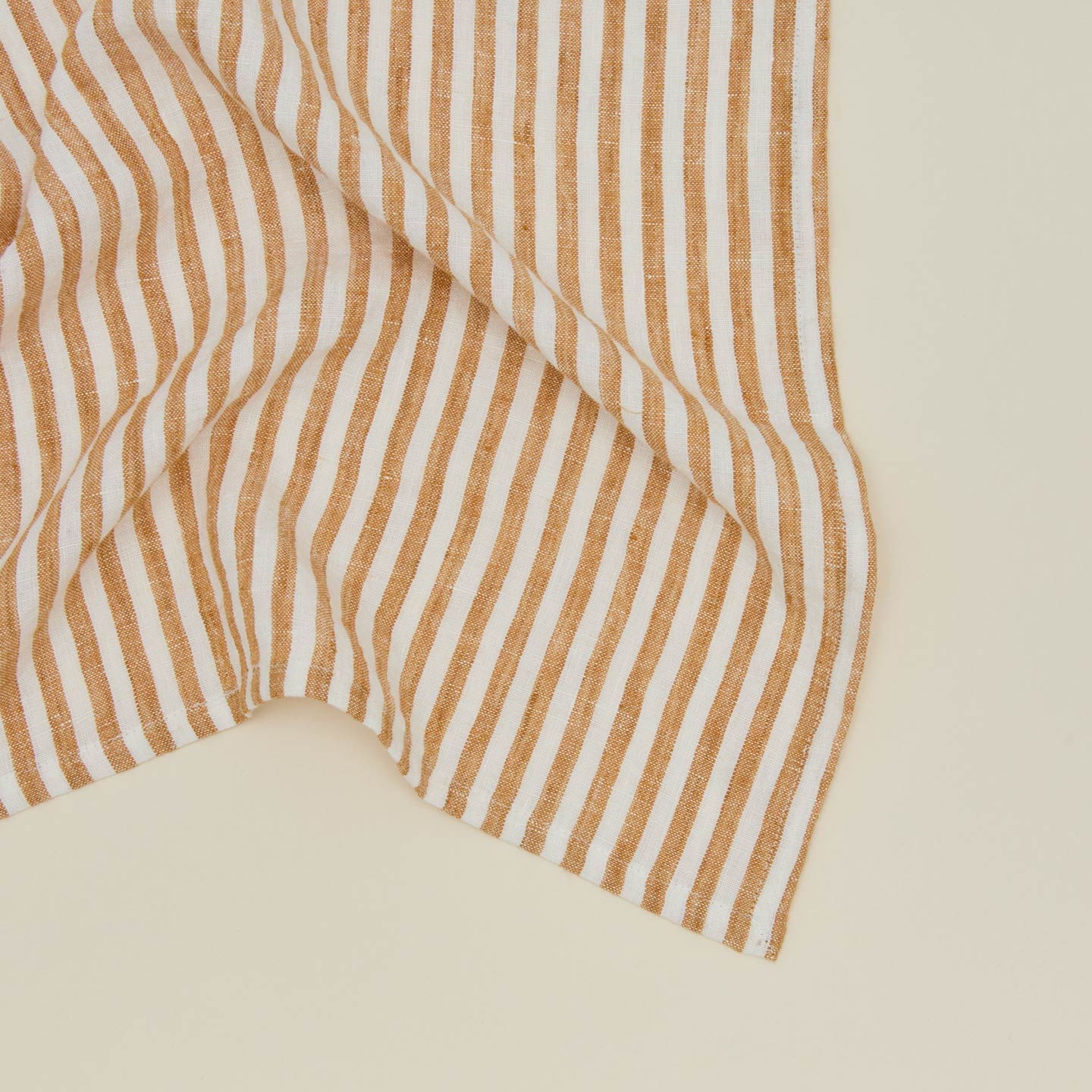 Close up view of Tell Me More leon striped napkin.