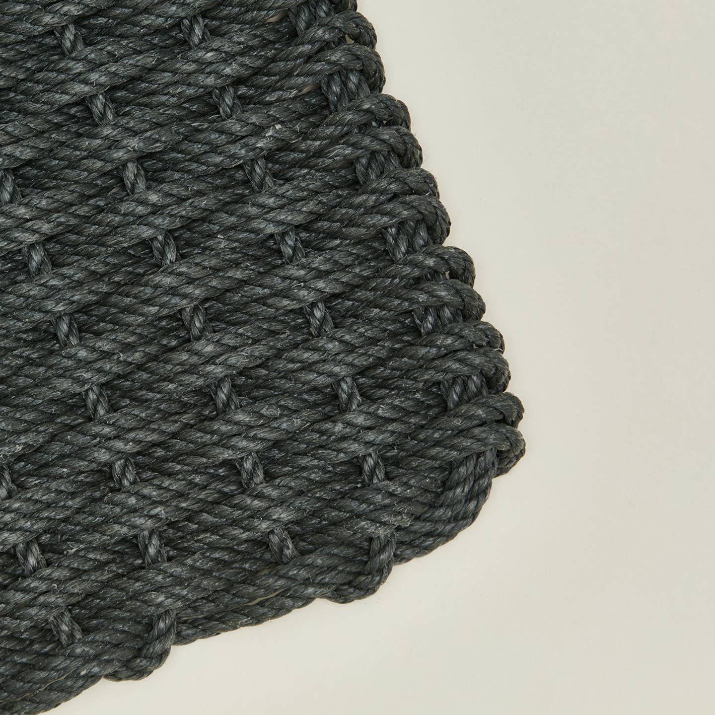 Close up view of woven doormat in blue spruce