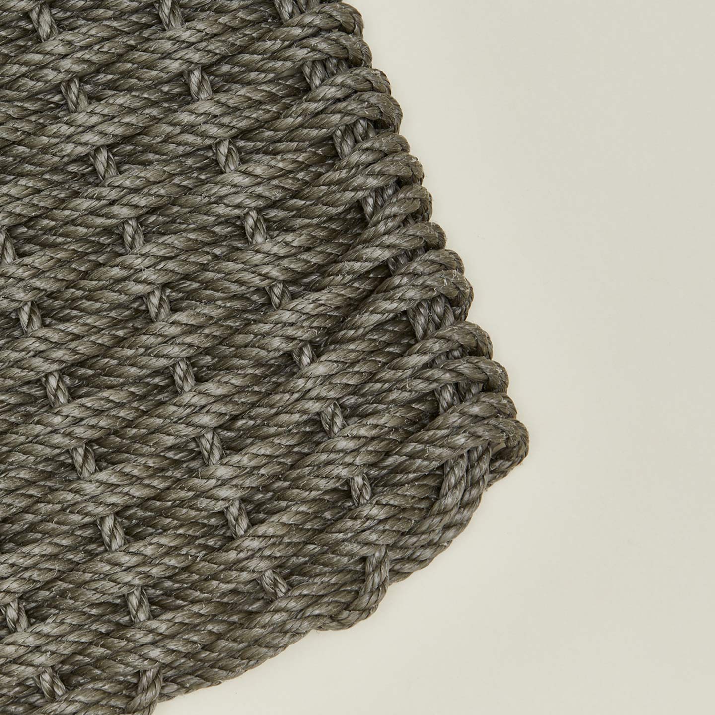Close up view of woven doormat in mushroom
