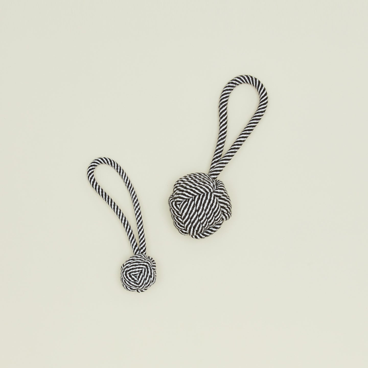 Large and small rope dog toys in black and white