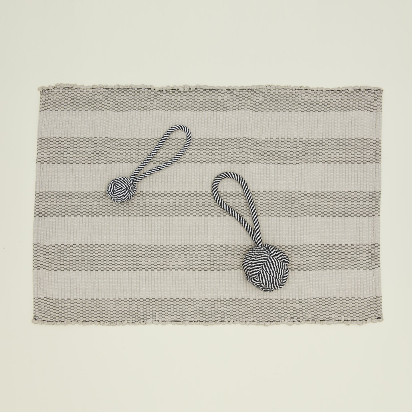 Large and smallrope dog toys on striped gray mat