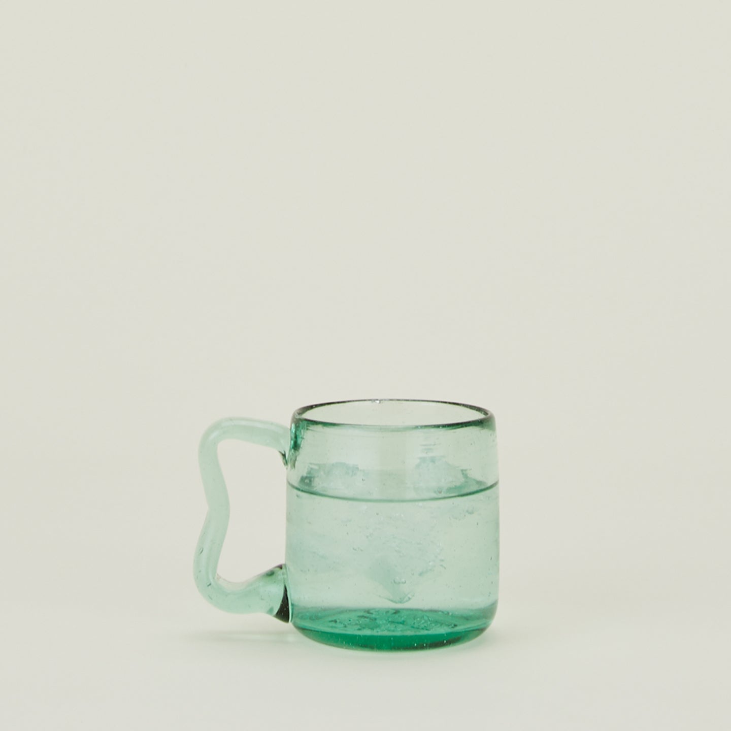 Wavy Recycled Small Mug filled with ice water.