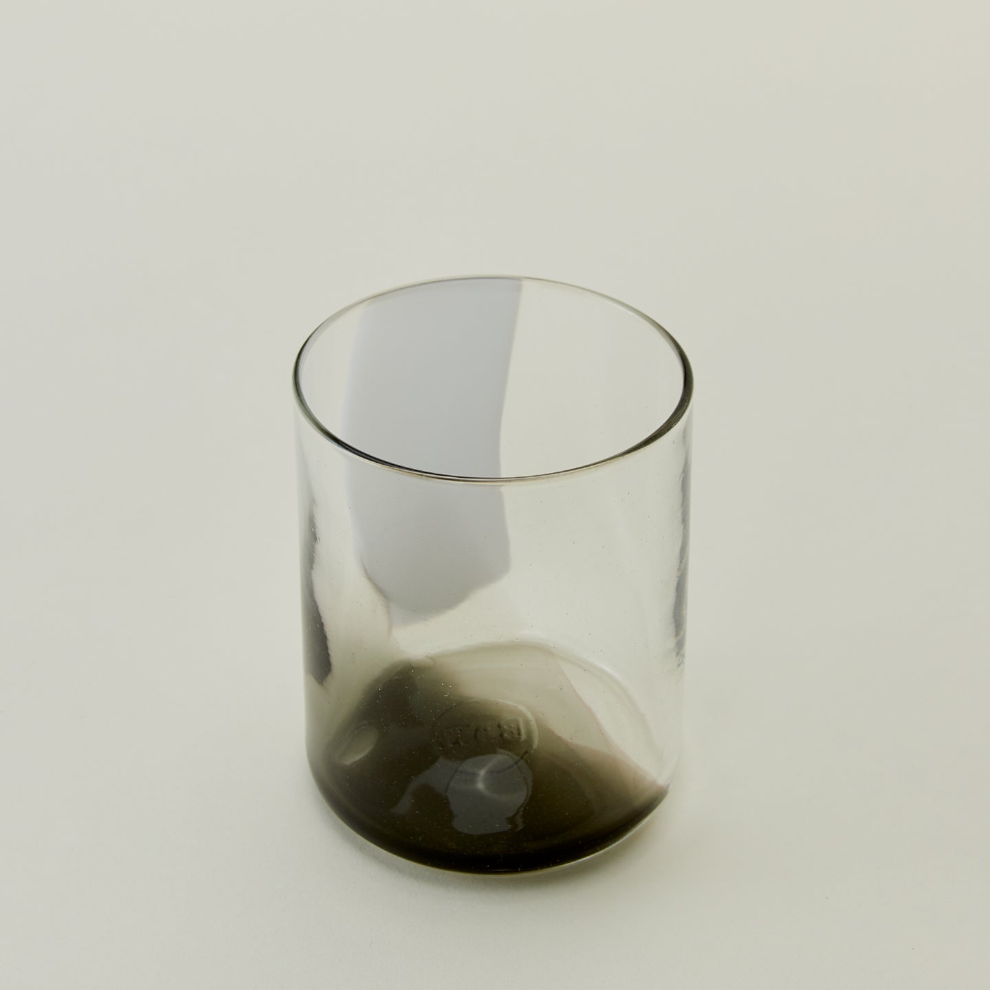 Close up of Blown Glass Tumbler in White and Grey.