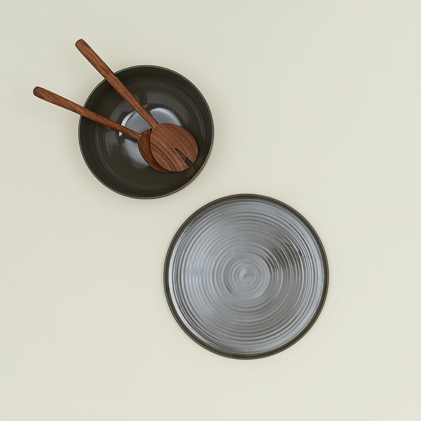 Essential Serving Platter and Serving Platter in Olive, with wood serving utensils.