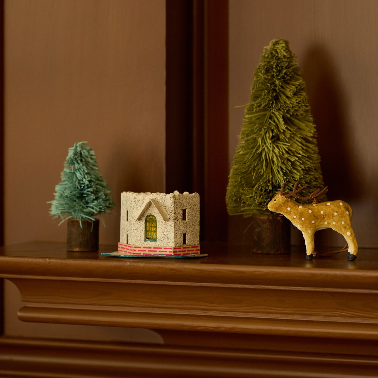 Bottlebrush trees on mantle with ornaments