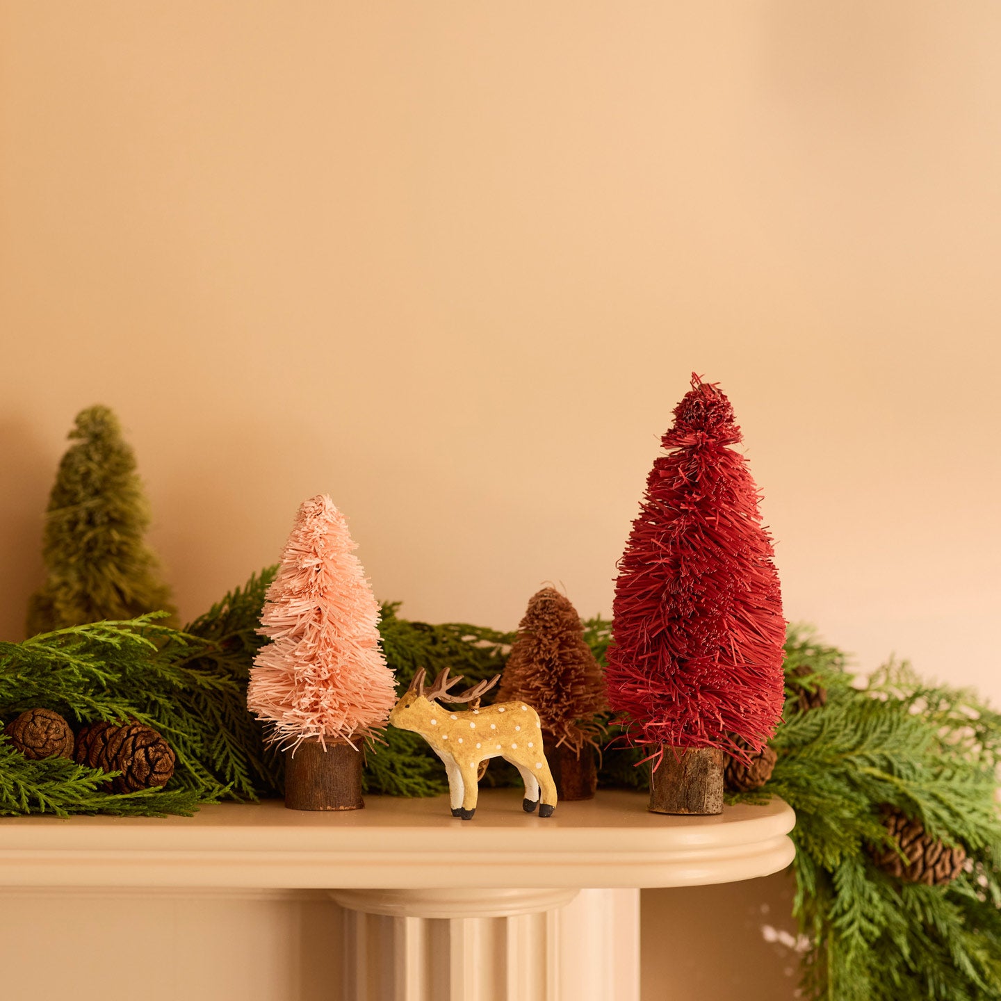 Bottlebrush tree on mantle with ornament and garland