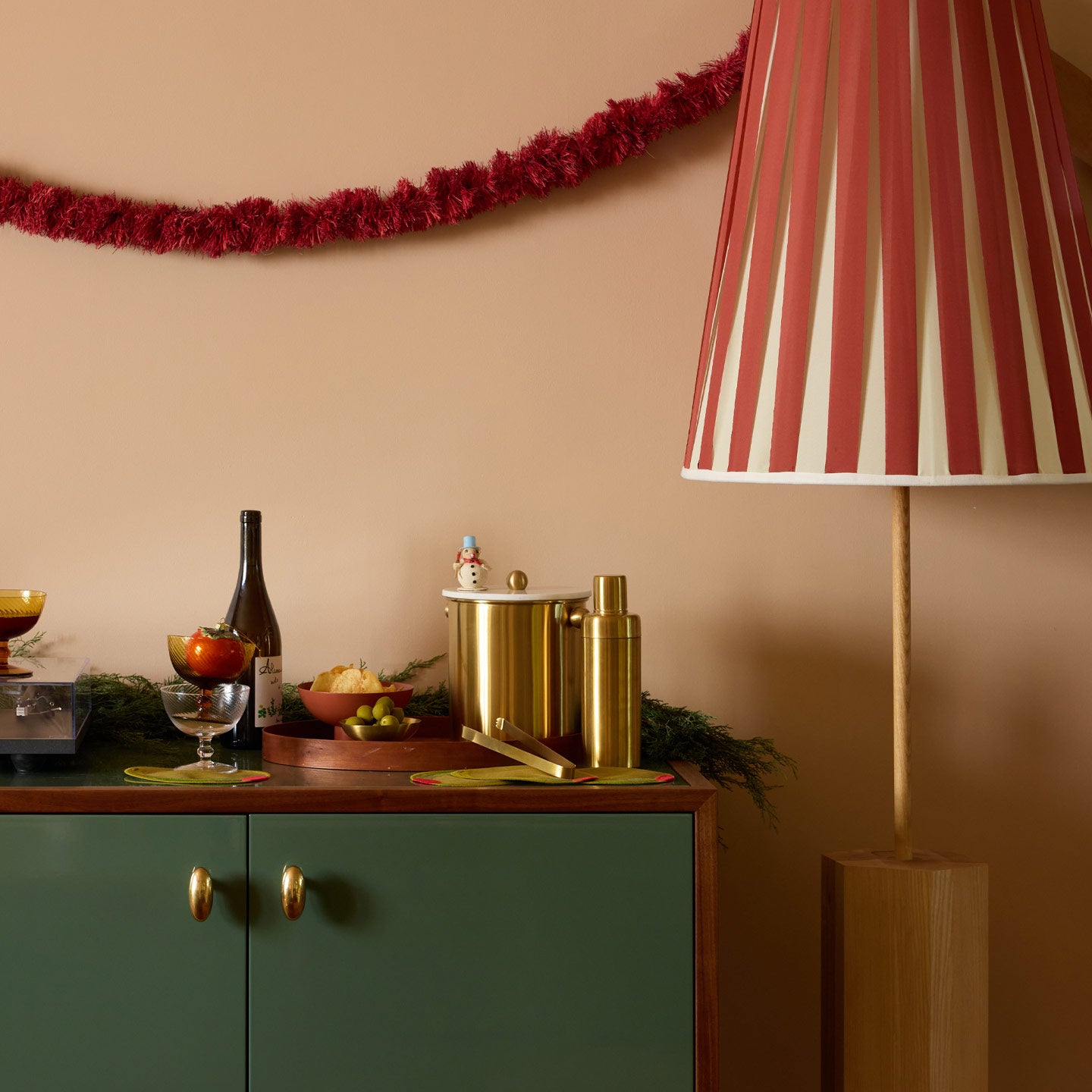 Home bar with large lamp and paper garland.