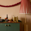 Home bar with large lamp and paper garland.