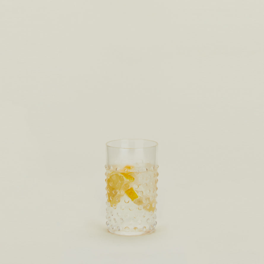 Hobnail Tumbler in Clear filled with water and fruit.