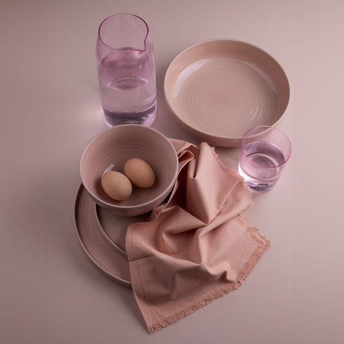Essential dinnerware, glassware, pitcher, and napkins in Blush tones.