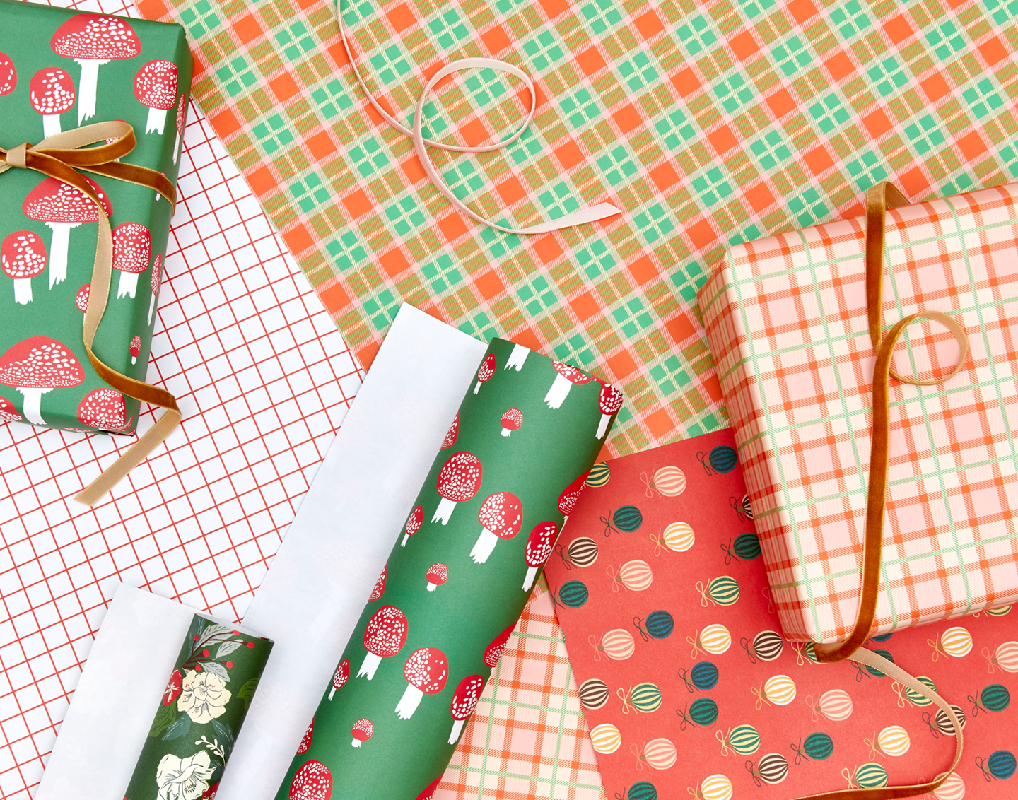 Gift wrap with various holiday patterns and velvet ribbon in various colors.