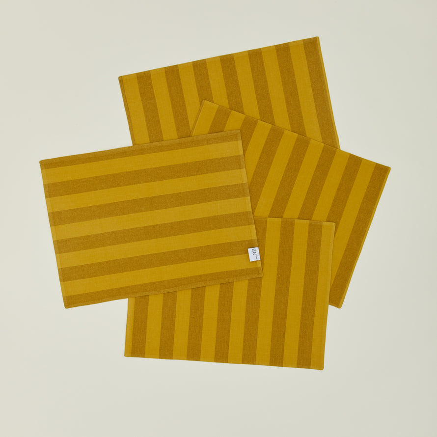 Set of four Essential Striped Placemats in Mustard and Bronze.