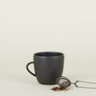 Stoneware Mug in Black with tea strainer.