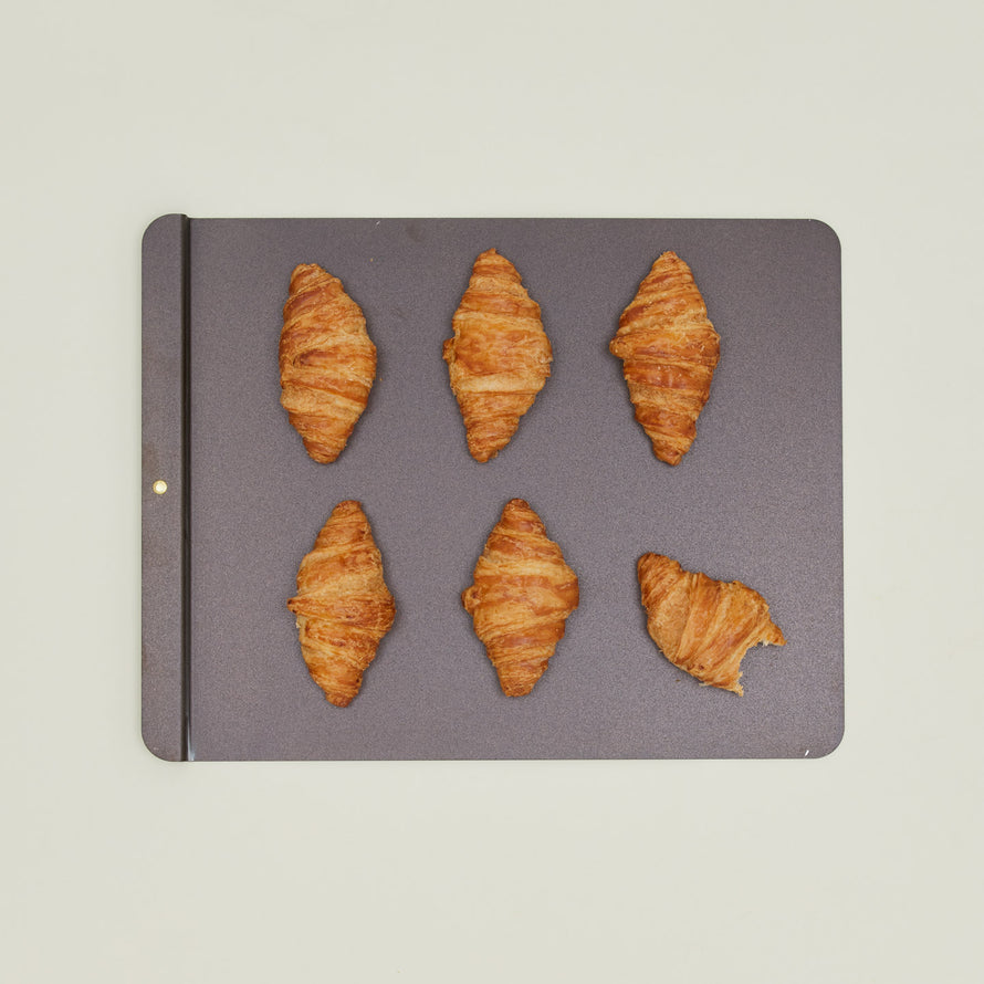 Large spun iron baking tray with croissants