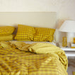 Essential Gingham Bedding in Mustard with nighstand.