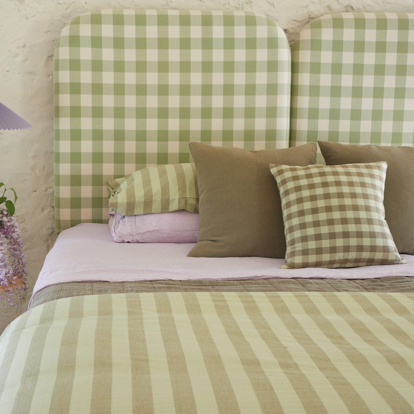 Bed with sage and lilac bedding and Essential Gingham Pillow in Olive.