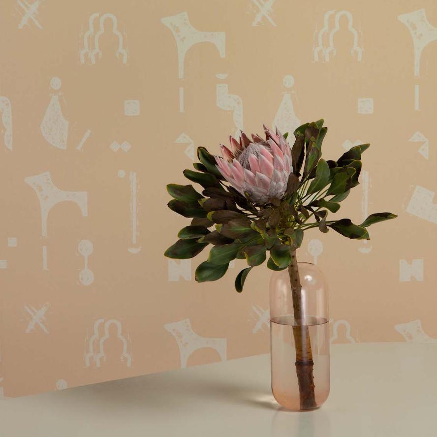 Aurora vase in blush in front of the Rubbings wallpaper.