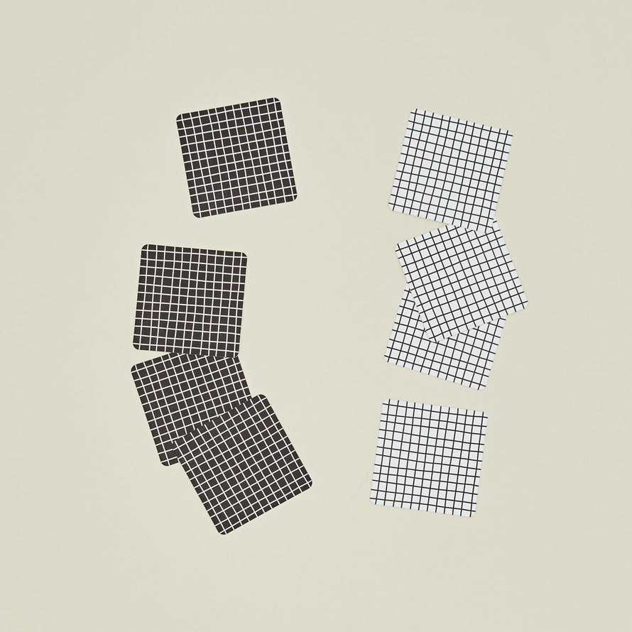 Set of eight reusable gridded paper coasters in two colorways.