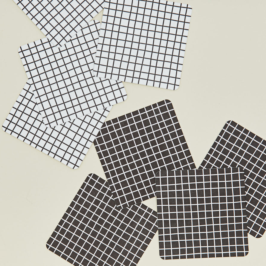 Close up of reusable gridded paper coasters.