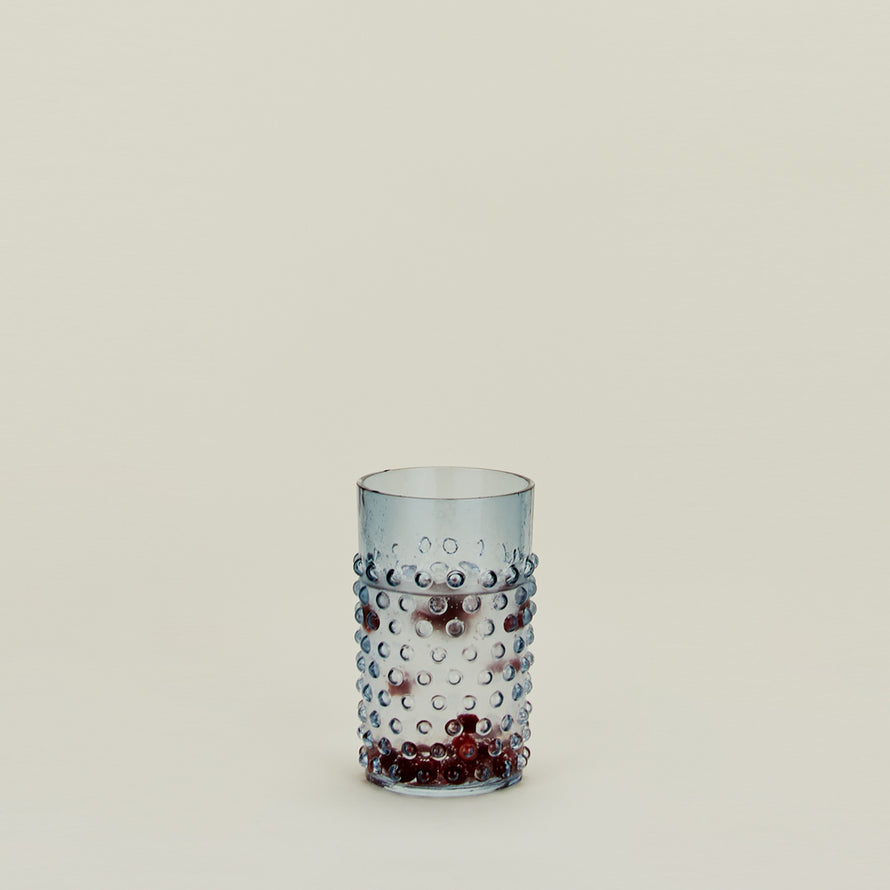 Hobnail Tumbler in Blue filled with water and fruit.