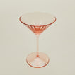 Three-quarter angle of ribbed blush martini glass.