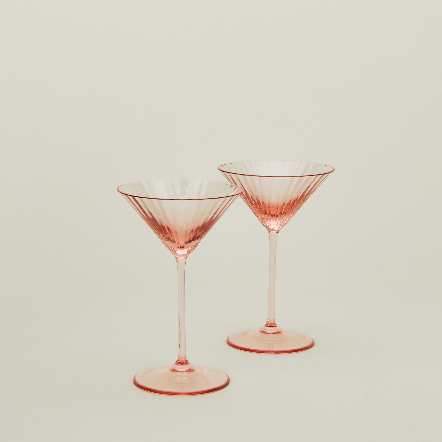 Set of two ribbed blush martini glasses.