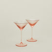 Set of two ribbed blush martini glasses.